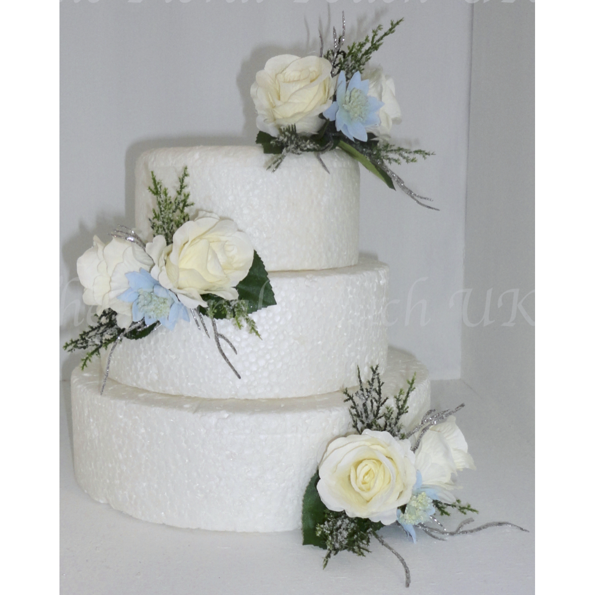 Ivory silk roses with pale blue Astrantia
Cypress sparkly pine foliage with silver twig sprays